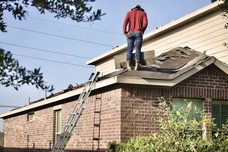 Professional roofer working on a residential roof in Lexington Square